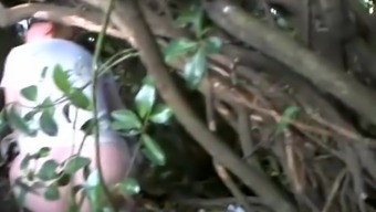 Woman caught beyond some bushes peeing