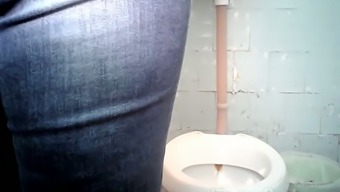 Pale skin stranger woman pulls down her panties and pisses in the toilet