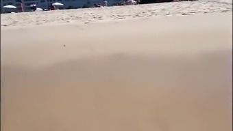 Large-assed harlot wears a flimsy bikini to the beach