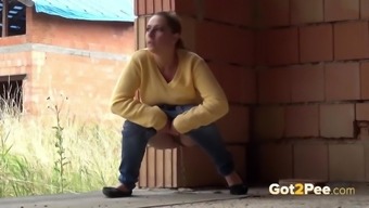 Blonde teen pisses on building to relieve pee desperation