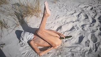 Amateur Nudist Teen Fucks Her Tight Pussy With A Huge Cucumber On A Public Beach. Ends With A Pee