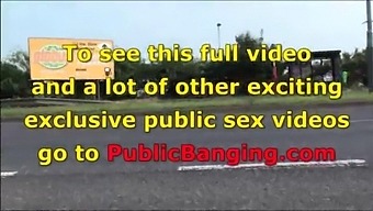 A gorgeous big breasted brunette in public street bus stop threesome orgy gang bang with 2 hung guys with big dicks fucking her with a blowjob and vaginal pussy sex action in front of all the car, bus, and truck drivers and people walking on the street