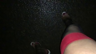 Walking in the rain in black and red nylons and sheer high heels