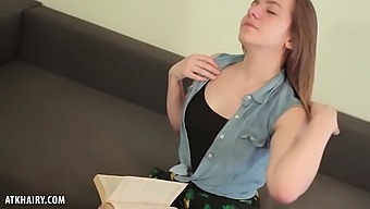 Ingrid stops reading to get naked so she can finger her pussy